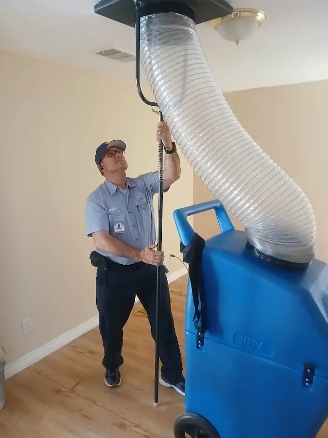 Furnace Tune-Up technician using HEPA equipment in Huntington